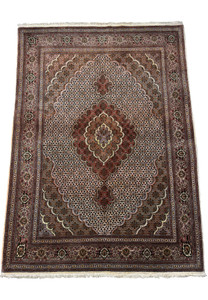 Full view of a 5x7 Persian Tabriz Mahi rug, illustrating the symmetry and balanced design of the central medallion, corner brackets, and comprehensive border pattern