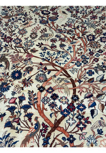 Close-up view of the upper part of a 4'2" x 6'9" Antique Persian Kashan rug, emphasizing the Tree of Life's branches and surrounding animal figures in vibrant hues