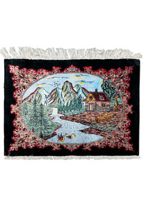 Detailed view of a hand-knotted Persian Qum silk rug displaying a central landscape scene with mountains, a river, and a cottage