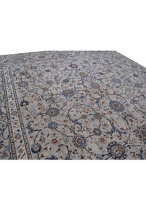 Close-up of the delicate and detailed floral motifs on a 11 x 18 Persian Kashan rug