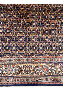 Close-up of the Persian Moud Rug's pattern, highlighting the complex floral motifs and rich colors.