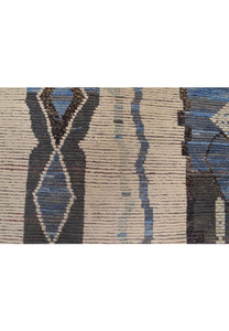 Detailed close-up of the rug's patterns, emphasizing the diamond shapes and the contrast between the dark and light colors.