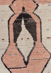 Detailed view of a diamond motif on a modern Moroccan rug, with a blend of peach, ivory, and black tones