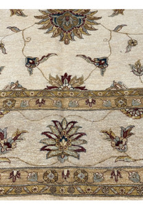 Close-up of the central medallion of the rug surrounded by elaborate floral motifs.
