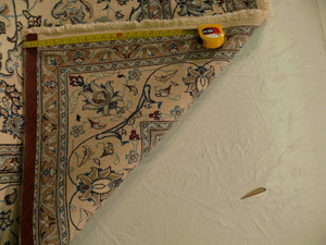Backside of Persian Nain rug showing cotton foundation and fine hand-knotted weave