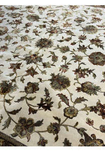 A close-up of the rug's weave, highlighting the detailed craftsmanship and subtle color variations in the background and motifs.