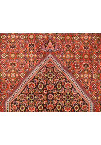 Top section of a Persian Bijar rug, emphasizing the detailed patterns and vibrant color scheme