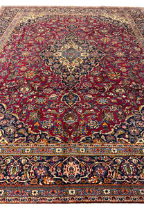 Top-down shot of a Persian Kashan rug, capturing the grandeur and complexity of its traditional design and craftsmanship