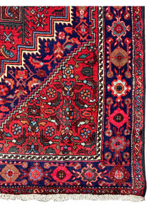 Corner detail of a Persian Gholtogh rug showcasing the precision of the weaver's art in blending patterns and colors