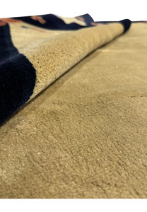 Partial rolled view of an 8'2" x 11'2" Vintage Art Deco Rug, highlighting the thickness and quality of the New Zealand wool fabric