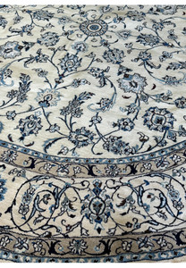 Ivory and blue Persian Nain round rug with traditional design.