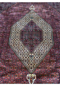 Detailed view of the Persian Bijar rug showcasing the elaborate central medallion with its symmetrical design and vibrant colors