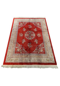 Side perspective of an unused red Chinese Art Deco wool rug, highlighting the luster and depth of the wool's texture