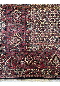 Close-up on the edge of a Persian Bidjar rug, emphasizing the tight weaving and the transition of patterns from the border to the central field