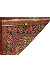 A close-up of the rug's back, zooming in on the dense knotting that gives Bijar rugs their renowned durability and the moniker "Iron Rugs.