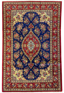 Full view of a 6'5" x 9'9" Persian Qum Kork and Silk Rug showcasing a deep navy blue field with a vibrant central medallion in red and cream, surrounded by intricate floral and vine motifs in red, cream, gold, and green accents