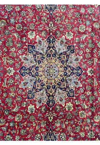 Corner detailing of Persian Isfahan rug - Close-up of the corner section of the Persian Isfahan rug, showing the complex border designs and rich coloration.