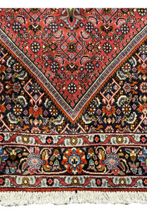 Close-up of the intricate patterns on the Persian Bidjar rug: A close-up image showing the intricate floral and geometric patterns within the central field of the Persian Bidjar rug, emphasizing the craftsmanship and detailed design.
