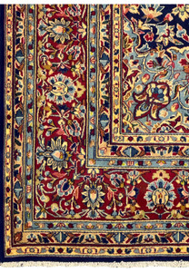 Focused close-up of the intricate floral design on a Persian Kerman Rug, demonstrating the high-quality weaving and the use of vibrant colors