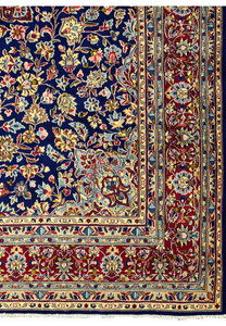 Close-up of the border on a Persian Kerman Rug, highlighting the vibrant colors and detailed floral motifs that frame the rug