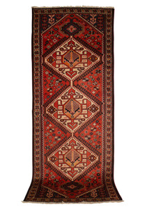 3'8" x 10' Persian Bakhtiar runner rug, showcasing its intricate geometric patterns and bold central medallions in rich red, orange, ivory, black, and green colors. The high-quality wool and fine craftsmanship are evident, making it a perfect addition to any hallway or narrow space.