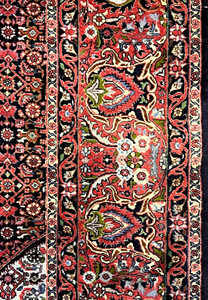 Close-up of the Bijar rug border showing tightly packed wool knots, bold red and navy colors, floral medallions, and exceptional clarity typical of Bijar rugs.