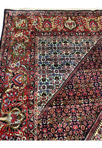 Inner border of a Persian Bijar rug displaying fine geometric detailing, ivory accents, dark navy outlines, and precise hand-knotting with high structural density.