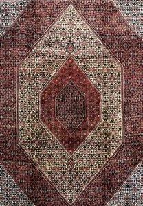 Midfield section of a 9.8 x 12.2 Persian Bijar rug highlighting intricate repeating patterns, ivory ground, and deep red and navy geometric ornamentation.