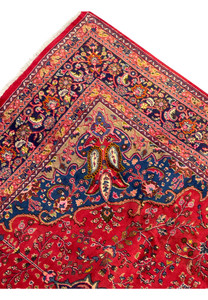 Close-up of the edge of the Persian Mashad rug, showcasing the fine weaving and detailed patterns.