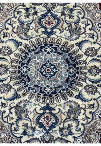 Zoomed-in view of the medallion on the 6'8 x 10'4 Persian Nain 9LAA Wool & Silk Rug, showcasing the intricate design and color details