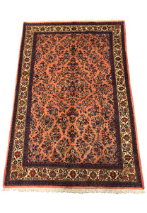 Perspective view of the 5'6" x 8'5" Persian Sarouk rug showcasing the detailed floral patterns.