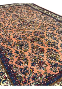 Angled view of the 5'6" x 8'5" Persian Sarouk rug showing the intricate design.