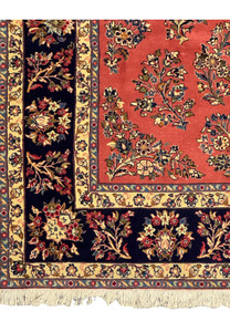 Close-up of corner design on a Persian Yazd rug, showcasing intricate vine motifs.