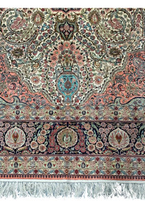 Lower section of a Persian Tabriz 100% silk rug with fringe detail.