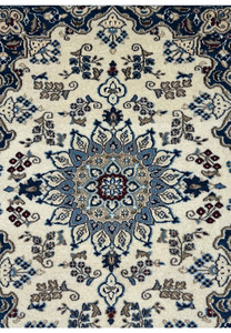Medallion of a 2'10 x 4'8 Persian Nain Rug with light blue and beige accents.