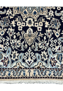 Detailed view of the lower border of the 3x5 Persian Nain rug.