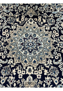 Close-up of the central medallion on the 3x5 Persian Nain rug.