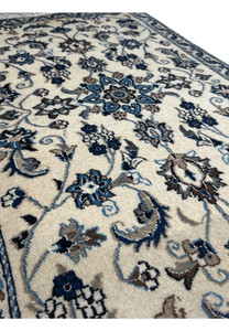 Side view of a Persian Nain Rug highlighting the detailed craftsmanship and intricate patterns.
