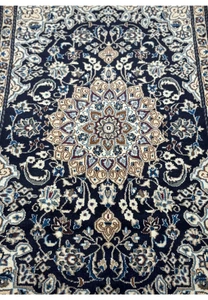 Close-up of the central medallion on the 3x5'3 Persian Nain Rug featuring floral motifs.