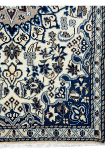 Lower part of the Persian Nain rug highlighting the border design and floral patterns with silk accents.