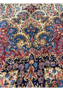 Close-up of a 9' x 17'8" Antique Persian Kerman Lavar Rug, showing intricate floral patterns