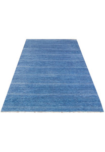 Wide view of blue 12x18 modern designer rug laid out flat