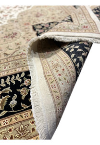 Folded view showing the backside of a 12'5" x 18' Persian Tabriz Rug, emphasizing the durability and fine structure of the weave.