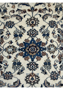 Central medallion of 3 x 4'4 Persian Nain Rug with intricate floral patterns in navy blue, brown, and ivory.