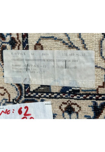 Tag on the backside of 3 x 4'4 Persian Nain Rug indicating its authenticity and origin.