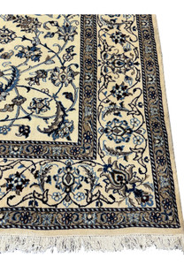 Close-up of the edge of the 8'2 x 11'6 Persian Nain rug showing detailed craftsmanship.