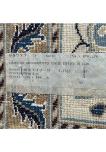 Tag of the 2'11 x 5'1 Persian Nain rug with details of its origin and craftsmanship.