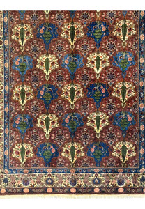 View of the lower part of a Persian Bakhtiar Rug, featuring tree-of-life motifs and birds.
