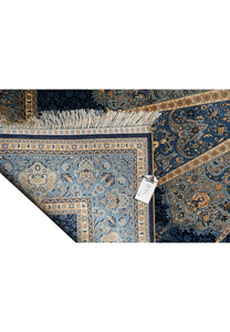 Backside weaving detail of 6x9 signed oriental silk rug, showing fine knot density."