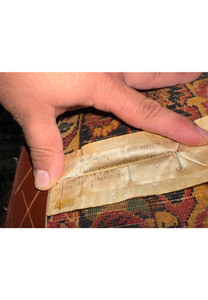 Back of antique Bijar rug with original European import label and wool foundation visible